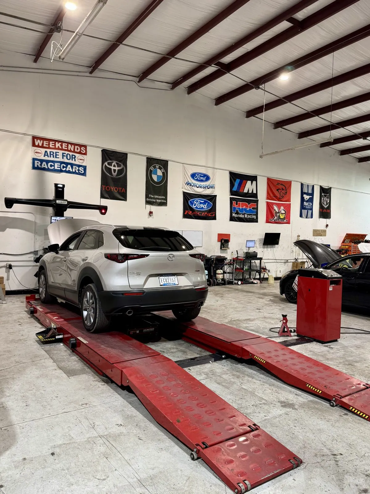 Mazda CX-30 on the wheel alignment rack at 239 Mechanics in Cape Coral