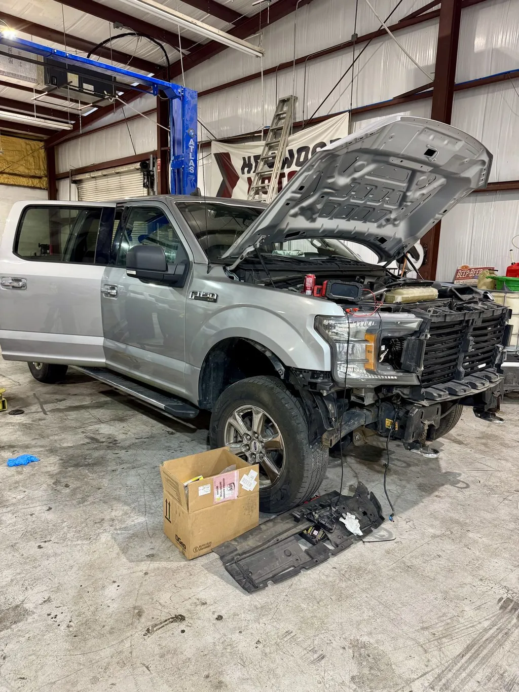 Technician working on a Ford F-150 engine at 239 Mechanics in Cape Coral
