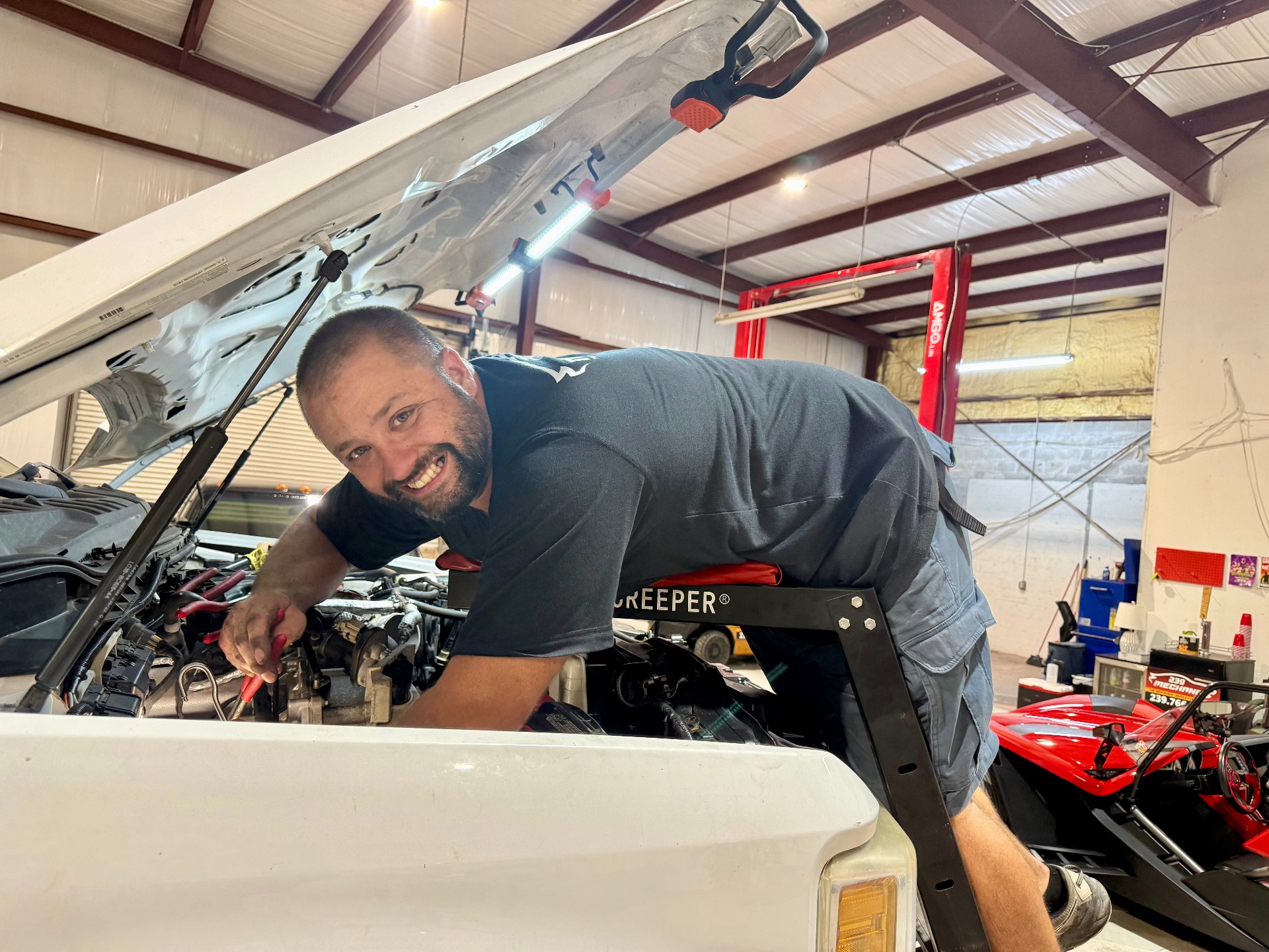 Friendly mechanic working on engine at 239 Mechanics Cape Coral