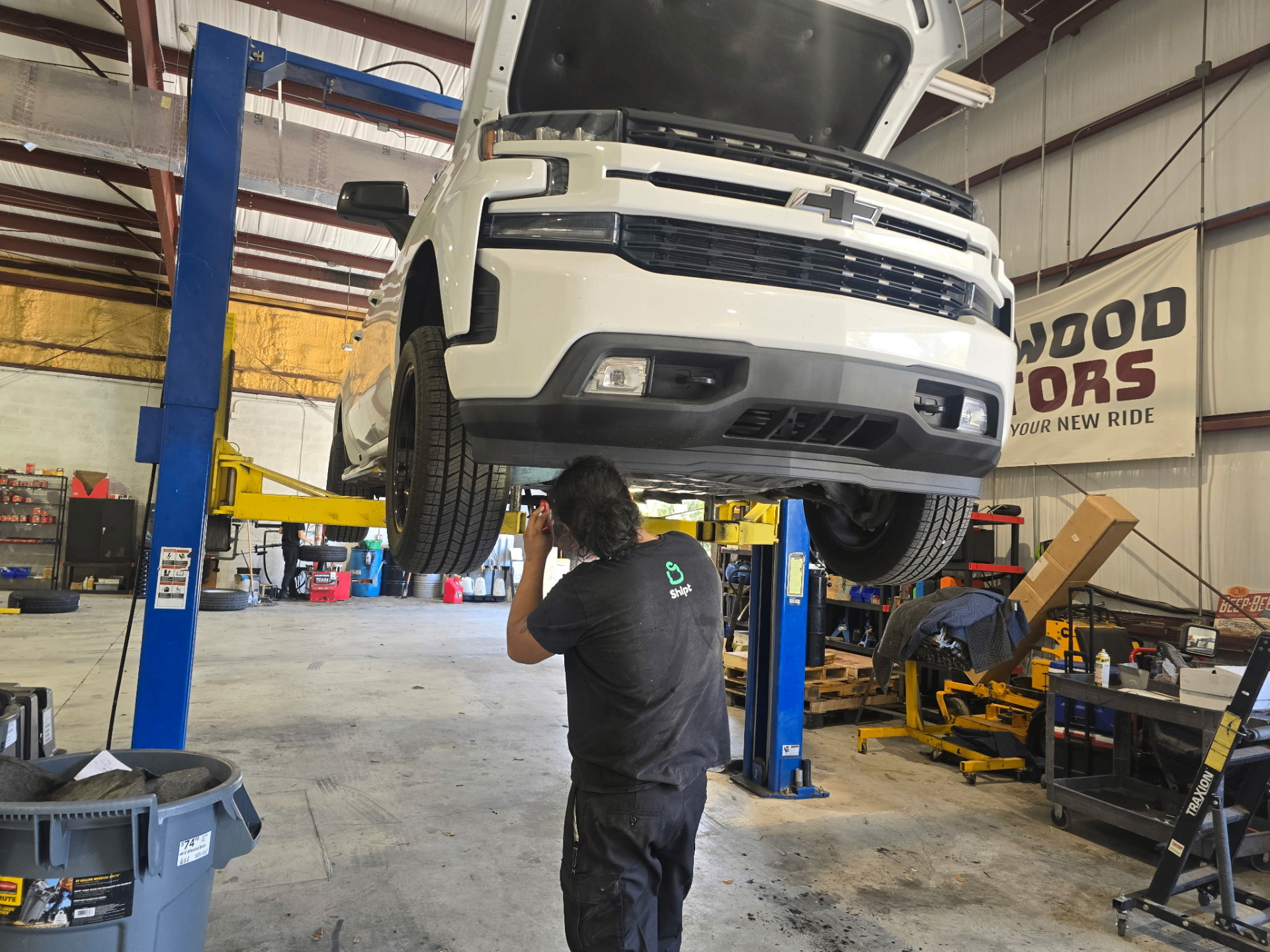 239 Mechanics technician inspecting a Chevy Silverado on the lift