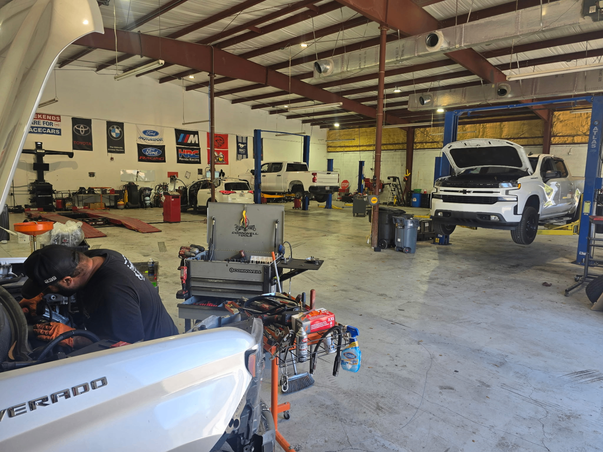 239 Mechanics shop interior with multiple vehicles being serviced