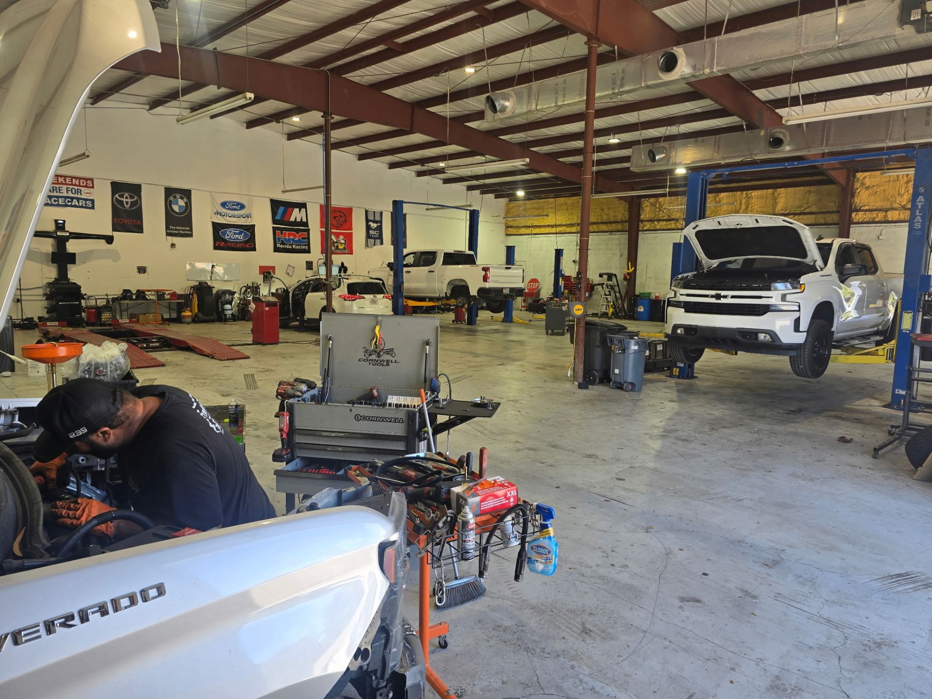 239 Mechanics shop interior with multiple vehicles being serviced